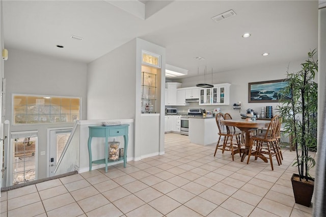 dining room featuring recessed lighting, light tile patterned floors, and visible vents
