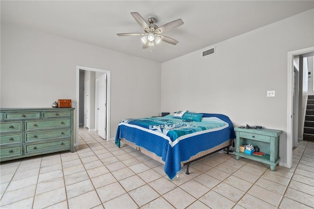 bedroom with light tile patterned floors, visible vents, baseboards, and ceiling fan