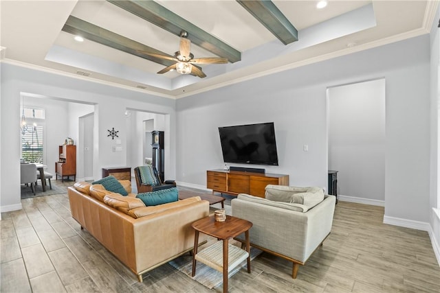 living room with a raised ceiling, visible vents, light wood-style floors, baseboards, and a ceiling fan
