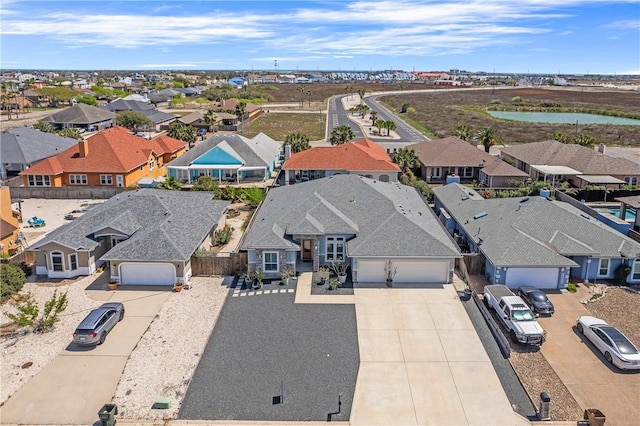 drone / aerial view with a residential view and a water view
