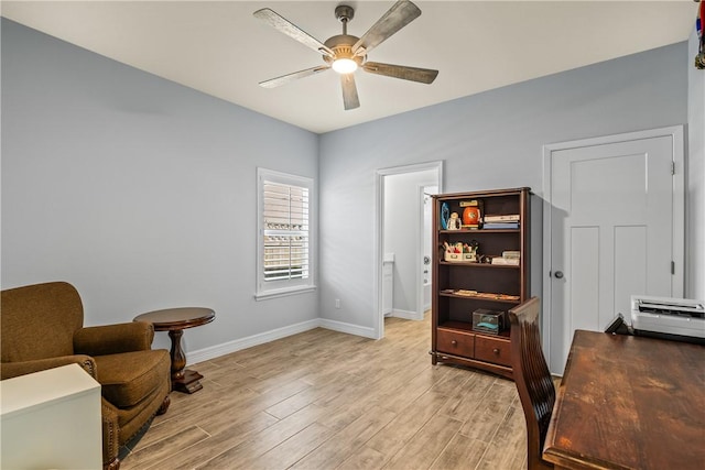 home office with ceiling fan, baseboards, and light wood-style floors