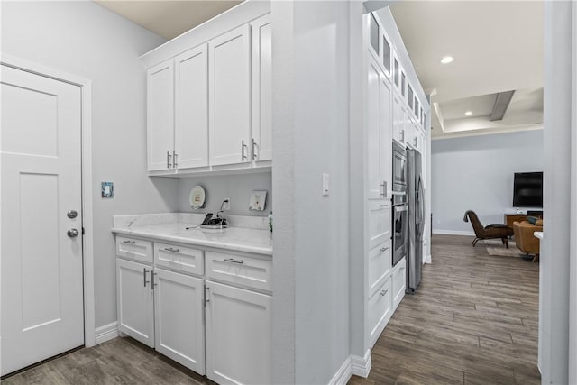 interior space featuring dark wood-style floors, recessed lighting, and baseboards