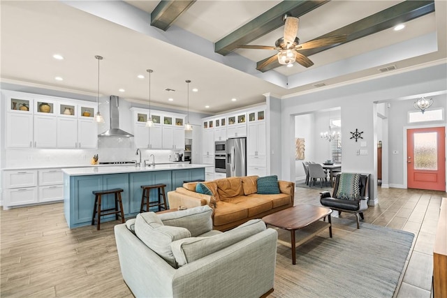 living room featuring light wood-style flooring, visible vents, beam ceiling, recessed lighting, and ceiling fan with notable chandelier