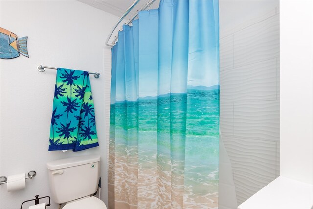 bathroom with curtained shower and toilet