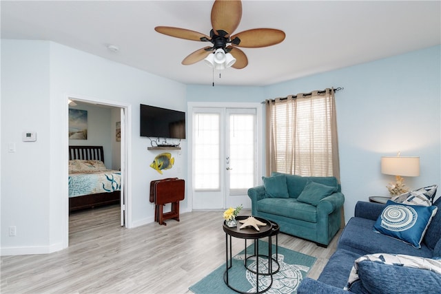 living room with ceiling fan, french doors, and light hardwood / wood-style floors