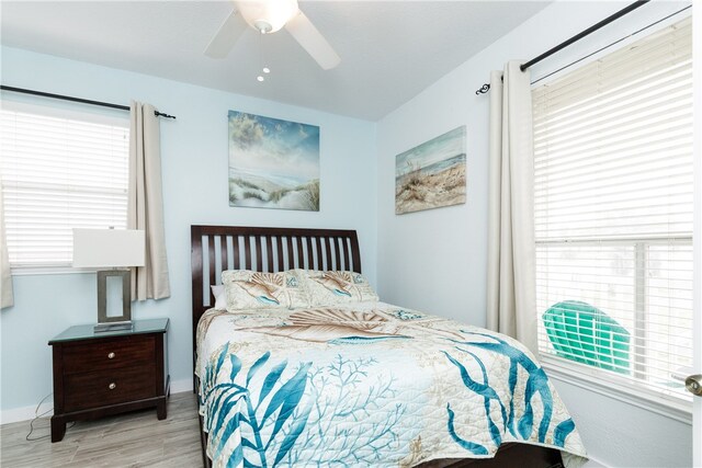 bedroom featuring light hardwood / wood-style floors and ceiling fan