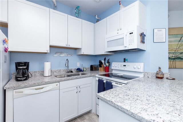 kitchen with white cabinetry, light wood-type flooring, sink, and white appliances