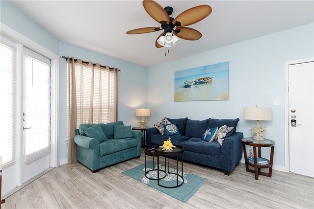 living room featuring ceiling fan and light hardwood / wood-style floors