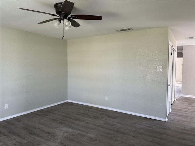 unfurnished room with ceiling fan and dark hardwood / wood-style floors