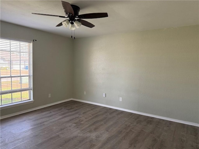 unfurnished room featuring ceiling fan and dark hardwood / wood-style floors