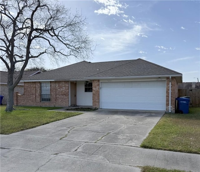 ranch-style house with a garage and a front lawn