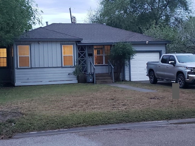 3459 Lawnview St, Corpus Christi, TX 78411 - ranch-style house with a garage, a shingled roof, and a front lawn