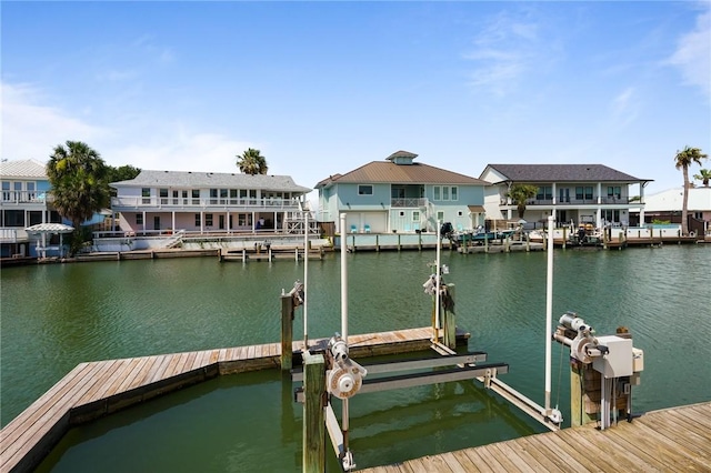 10 Kingfisher Ln, Rockport, TX 78382 - dock with boat lift, a water view, and a residential view