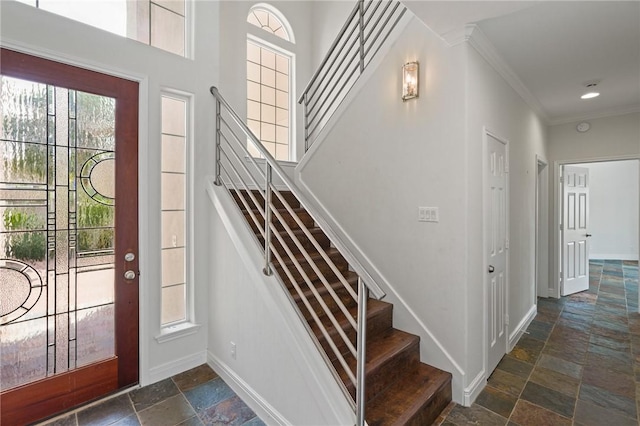 10 Kingfisher Ln, Rockport, TX 78382 - foyer with stone tile flooring, stairs, and ornamental molding