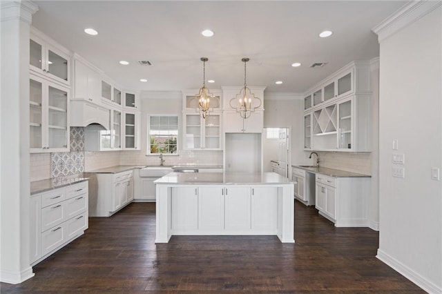 10 Kingfisher Ln, Rockport, TX 78382 - kitchen with backsplash, dishwasher, a center island, glass insert cabinets, and recessed lighting