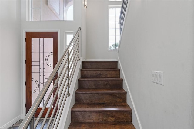 10 Kingfisher Ln, Rockport, TX 78382 - staircase featuring baseboards and a towering ceiling