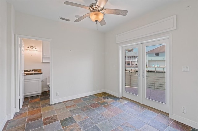 10 Kingfisher Ln, Rockport, TX 78382 - unfurnished room with stone tile floors, french doors, and ceiling fan