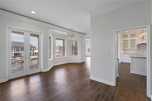 10 Kingfisher Ln, Rockport, TX 78382 - spare room featuring a chandelier, plenty of natural light, crown molding, dark wood-style floors, and recessed lighting