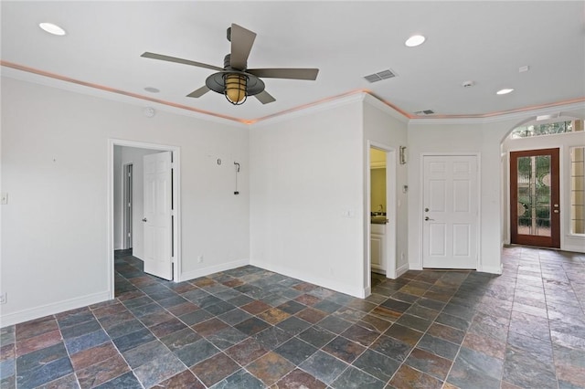 10 Kingfisher Ln, Rockport, TX 78382 - spare room with stone tile floors, arched walkways, crown molding, recessed lighting, and ceiling fan