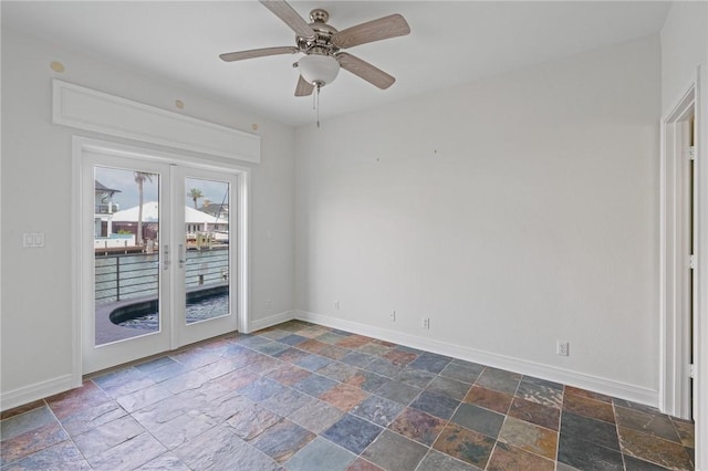 10 Kingfisher Ln, Rockport, TX 78382 - spare room with french doors, stone tile flooring, and ceiling fan