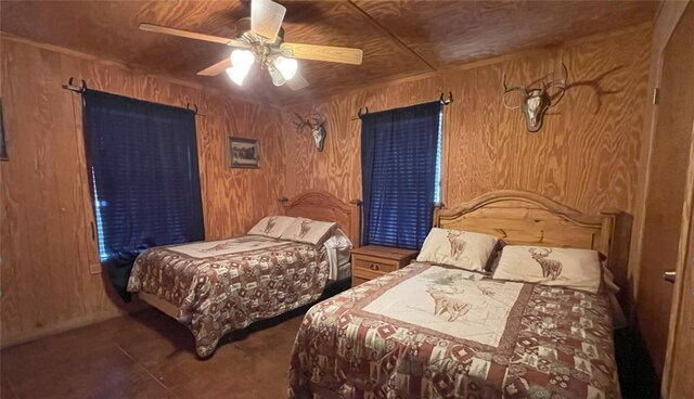 197 N Tomahawk Way, Concan, TX 78838 - bedroom featuring wood walls and ceiling fan