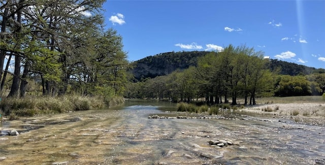 197 N Tomahawk Way, Concan, TX 78838 - view of mountain backdrop with a forest