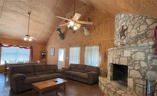 197 N Tomahawk Way, Concan, TX 78838 - living area with ceiling fan, healthy amount of natural light, tile patterned flooring, wooden walls, and high vaulted ceiling