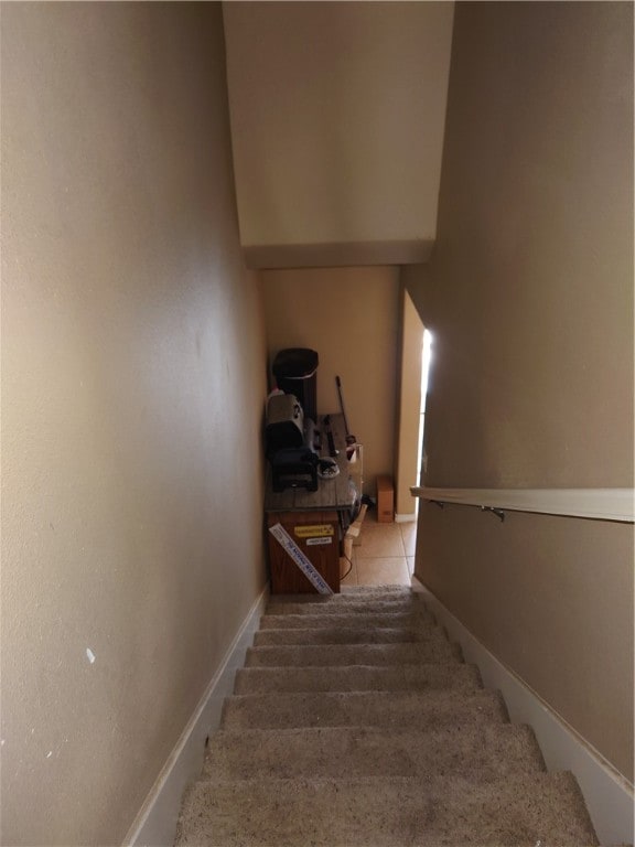 stairs featuring tile patterned floors