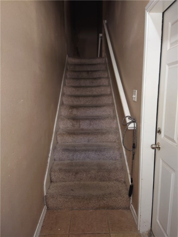 stairway featuring tile patterned floors