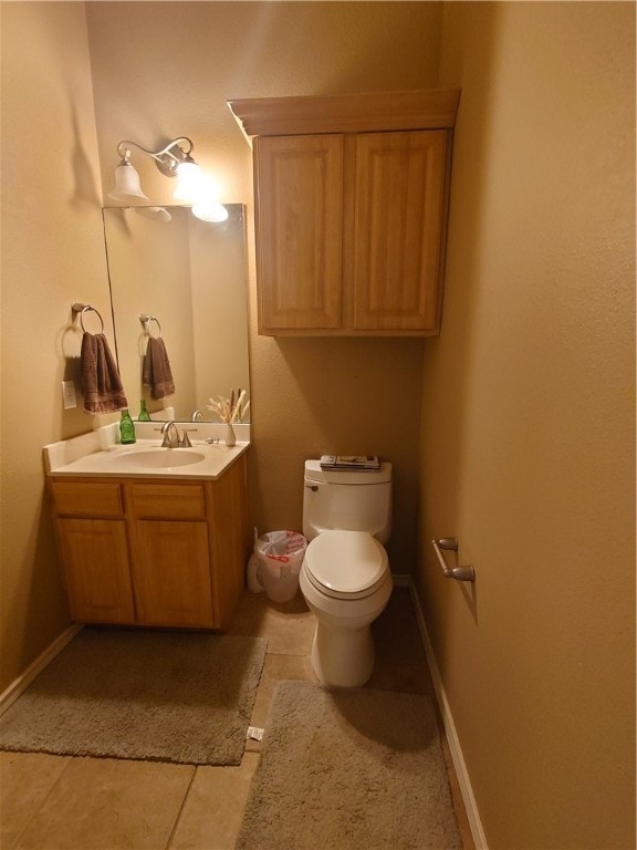 bathroom featuring tile patterned flooring, vanity, and toilet