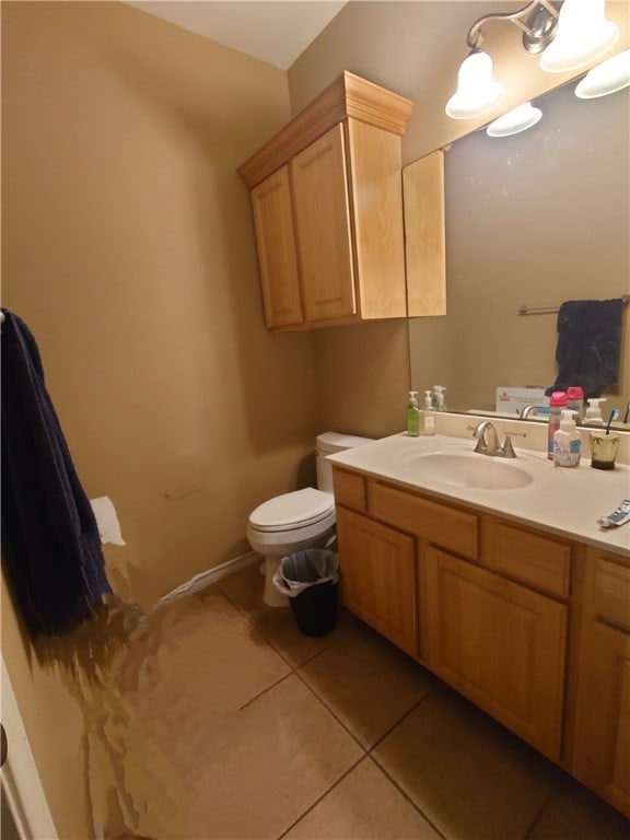 bathroom featuring toilet, vanity, and tile patterned floors