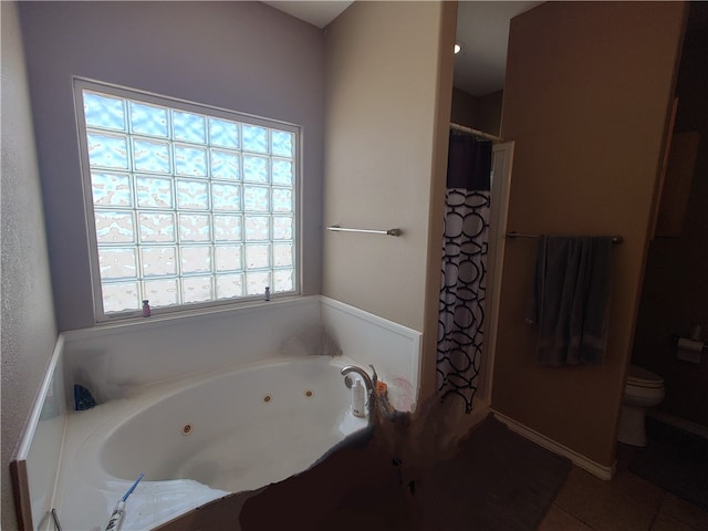 bathroom with tile patterned flooring, toilet, and separate shower and tub