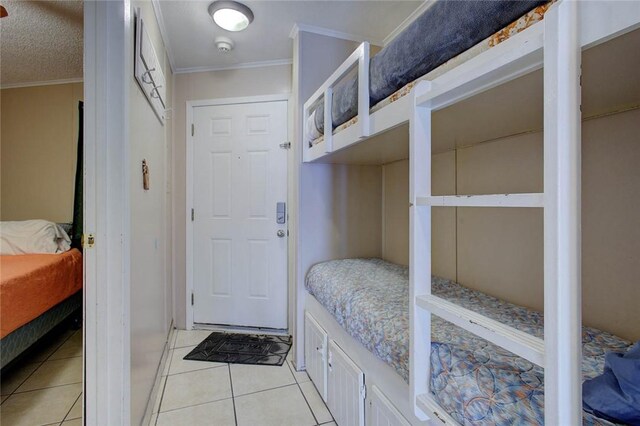 3938 Surfside Blvd Unit 3114, Corpus Christi, TX 78402 - bedroom featuring crown molding and light tile patterned floors