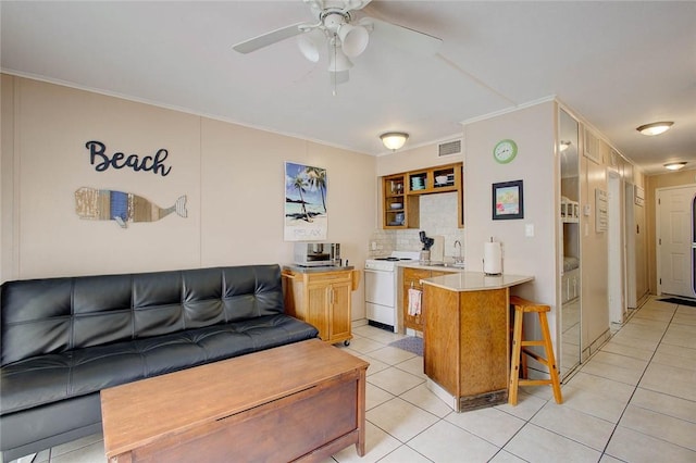 3938 Surfside Blvd Unit 3114, Corpus Christi, TX 78402 - kitchen featuring white range, a sink, a peninsula, a kitchen breakfast bar, and light tile patterned floors