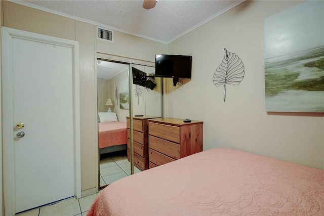 3938 Surfside Blvd Unit 3114, Corpus Christi, TX 78402 - bedroom featuring light tile patterned flooring, crown molding, vaulted ceiling, a textured ceiling, and ceiling fan