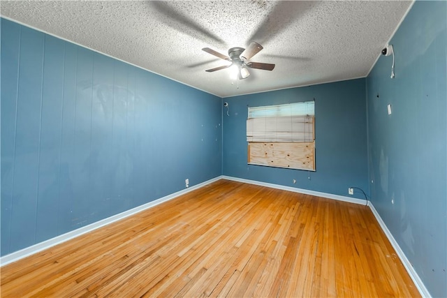 445 Troy Dr, Corpus Christi, TX 78412 - spare room with hardwood / wood-style flooring, ceiling fan, baseboards, and a textured ceiling