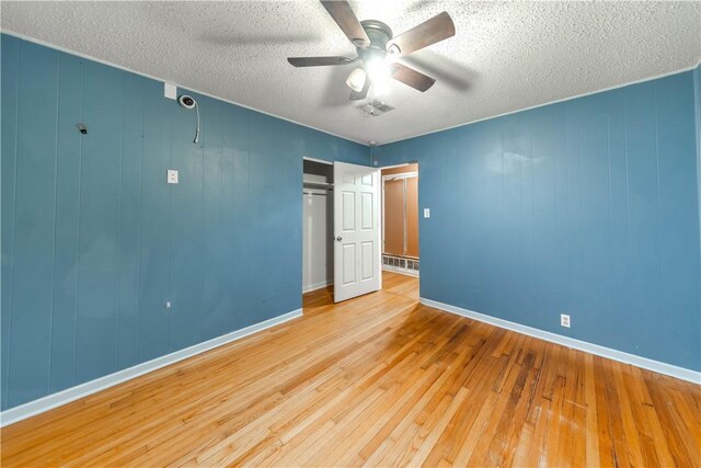 445 Troy Dr, Corpus Christi, TX 78412 - unfurnished bedroom with hardwood / wood-style floors, a textured ceiling, a closet, and baseboards