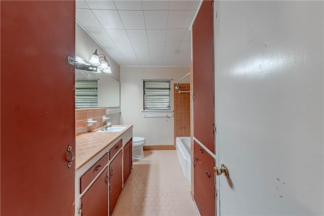 445 Troy Dr, Corpus Christi, TX 78412 - bathroom featuring toilet, vanity, and bathtub / shower combination