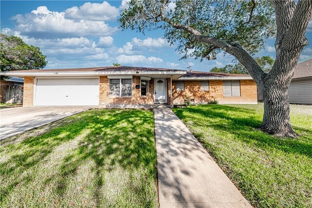 445 Troy Dr, Corpus Christi, TX 78412 - ranch-style house with an attached garage, concrete driveway, a front lawn, and brick siding