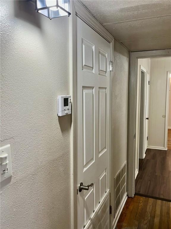 4225 Lowman St, Corpus Christi, TX 78411 - hall with dark wood-style flooring and a textured wall