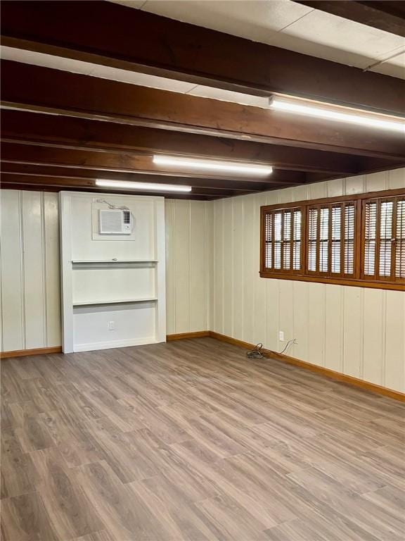 4225 Lowman St, Corpus Christi, TX 78411 - below grade area featuring wood finished floors, baseboards, and a wall unit AC