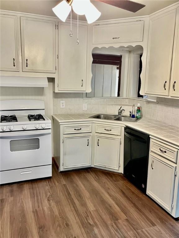 4225 Lowman St, Corpus Christi, TX 78411 - kitchen featuring gas range gas stove, dishwasher, a sink, tile countertops, and backsplash