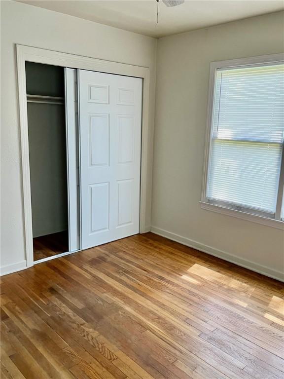 4225 Lowman St, Corpus Christi, TX 78411 - unfurnished bedroom with light wood-type flooring, a closet, and baseboards