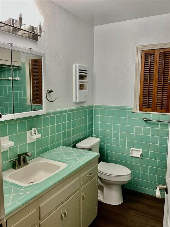 4225 Lowman St, Corpus Christi, TX 78411 - bathroom featuring tile walls, wood finished floors, vanity, a wainscoted wall, and heating unit
