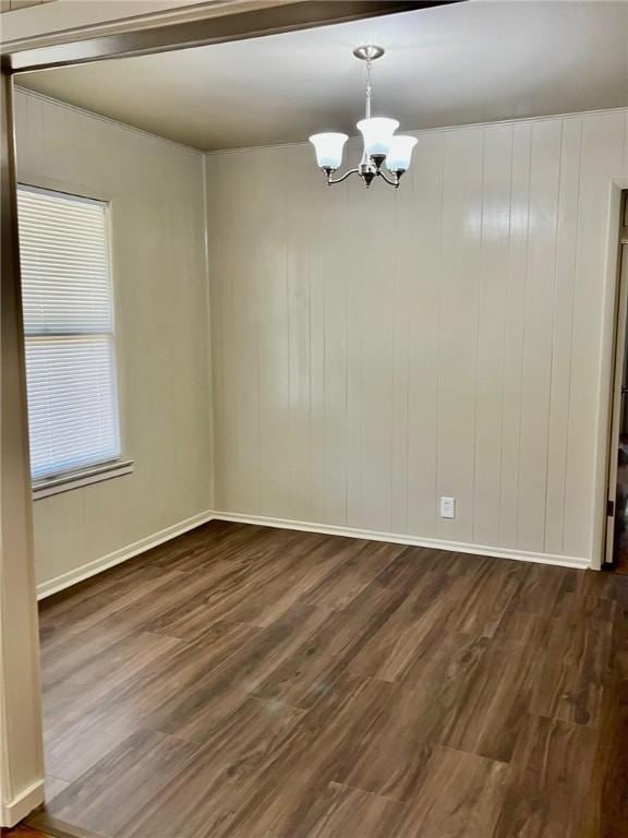 4225 Lowman St, Corpus Christi, TX 78411 - unfurnished room featuring a chandelier, dark wood-type flooring, and baseboards