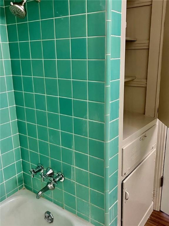 4225 Lowman St, Corpus Christi, TX 78411 - bathroom featuring shower / bathtub combination and wood finished floors