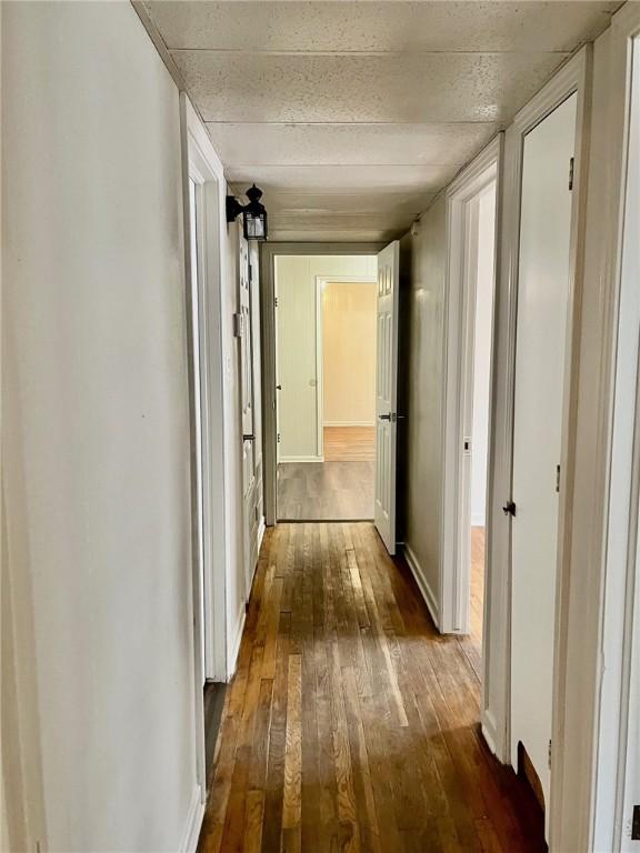 4225 Lowman St, Corpus Christi, TX 78411 - hallway featuring dark wood-type flooring and baseboards