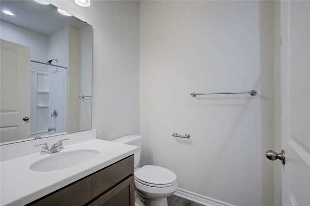 bathroom featuring hardwood / wood-style floors, vanity, and toilet