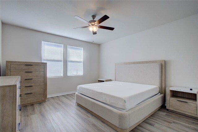 bedroom with ceiling fan and light hardwood / wood-style flooring