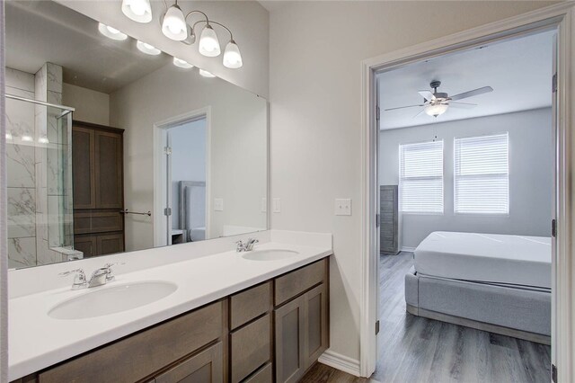 bathroom featuring an enclosed shower, hardwood / wood-style floors, vanity, and ceiling fan